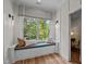 Cozy window seat with patterned pillows offering a view of the verdant outdoors at 387 Riverstone Dr, Pittsboro, NC 27312