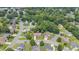 An aerial view shows this home with a lush treed landscape and a well-maintained lawn in a lovely neighborhood at 412 Whitt Ave, Burlington, NC 27215