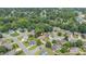 An aerial view shows this home with a lush treed landscape and a well-maintained lawn in a lovely neighborhood at 412 Whitt Ave, Burlington, NC 27215