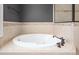 Bathroom featuring a large soaking tub with tile surround, and oil rubbed bronze fixtures at 412 Whitt Ave, Burlington, NC 27215