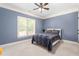 Bedroom with a queen size bed, overhead fan and a large window at 412 Whitt Ave, Burlington, NC 27215