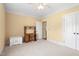 Neutral carpeted bedroom featuring a desk, storage, and double closet doors at 412 Whitt Ave, Burlington, NC 27215