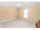 Bright bedroom with large window, neutral carpet and ceiling fan at 412 Whitt Ave, Burlington, NC 27215