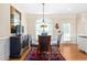 Inviting dining room featuring a glass top table, modern lighting, and neutral wall paint at 412 Whitt Ave, Burlington, NC 27215