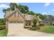 Charming single-Gathering home featuring a brick facade, two car garage, and manicured landscaping at 412 Whitt Ave, Burlington, NC 27215