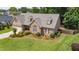 Beautiful aerial front exterior view with a well-kept lawn and landscaping at this attractive brick home at 412 Whitt Ave, Burlington, NC 27215