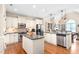 Modern kitchen with stainless steel appliances, a center island, granite countertops, and hardwood flooring at 412 Whitt Ave, Burlington, NC 27215
