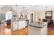 Open-concept kitchen with granite counters, stainless appliances, hardwood floors, and adjacent dining area at 412 Whitt Ave, Burlington, NC 27215