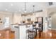 Bright kitchen with stainless steel appliances, granite counters, and an island with bar stool seating at 412 Whitt Ave, Burlington, NC 27215