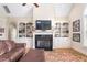 Inviting living room with a vaulted ceiling, built-in bookshelves, and a cozy fireplace at 412 Whitt Ave, Burlington, NC 27215