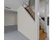 Basement staircase with white railings and stained wooden steps, leading to a finished basement area at 420 Nelson St, Durham, NC 27707
