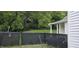 Backyard featuring lush trees, green grass, privacy fence and a portion of the house at 426 Smith St, Burlington, NC 27217