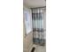 Bathroom featuring a window and a bathtub with a stylish blue and white shower curtain at 426 Smith St, Burlington, NC 27217