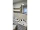 Bathroom with single sink vanity, toilet, decorative wall shelf, and mirror at 426 Smith St, Burlington, NC 27217