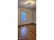 Bedroom with hardwood flooring and ceiling fan light fixture at 426 Smith St, Burlington, NC 27217
