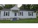 Charming single-story home with white siding, black shutters, and a covered front porch at 426 Smith St, Burlington, NC 27217