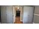 Hallway with hardwood floors, baseboard trim, and two wardrobe closets at 426 Smith St, Burlington, NC 27217