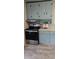 Cozy kitchen featuring an oven, blue cabinets, and vinyl floor at 426 Smith St, Burlington, NC 27217
