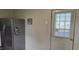 Stainless steel refrigerator next to a door to the outside at 426 Smith St, Burlington, NC 27217