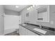 Bathroom featuring double sinks, gray countertops, and white cabinetry, and hardwood floors at 427 Elm Ct, Burlington, NC 27217