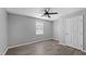 Neutral bedroom featuring a ceiling fan, window with blinds, and stylish flooring at 427 Elm Ct, Burlington, NC 27217