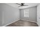 A bedroom featuring neutral walls, hardwood flooring, a ceiling fan, and a window at 427 Elm Ct, Burlington, NC 27217