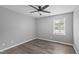 A bedroom featuring neutral walls, hardwood flooring, a ceiling fan, and a window at 427 Elm Ct, Burlington, NC 27217