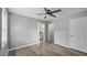 Bedroom features hardwood floors, two white doors and trim, and a ceiling fan at 427 Elm Ct, Burlington, NC 27217