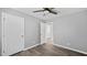 A gray bedroom featuring hardwood floors, two white doors and trim at 427 Elm Ct, Burlington, NC 27217