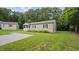 Charming single-story home with well-maintained lawn, driveway, and beautiful green trees at 427 Elm Ct, Burlington, NC 27217