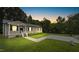 Charming home exterior featuring a well-maintained lawn, paved driveway and inviting front porch at 427 Elm Ct, Burlington, NC 27217