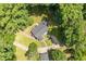 Aerial view of a home surrounded by lush trees and landscaping with a circular driveway at 4703 Pleasant Green Rd, Durham, NC 27705