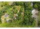 Expansive wooded lot featuring mature trees, outbuildings, a charming home, and a serene stream at 4703 Pleasant Green Rd, Durham, NC 27705