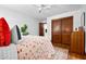Bright, airy bedroom with ceiling fan, closet, and neutral walls. Hardwood flooring is a plus at 4703 Pleasant Green Rd, Durham, NC 27705