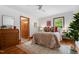 Bright bedroom with hardwood floors, closet and view of the lush backyard through the energy efficient windows at 4703 Pleasant Green Rd, Durham, NC 27705