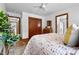 Bright bedroom has hardwood floors, a ceiling fan, and a large closet with wooden doors at 4703 Pleasant Green Rd, Durham, NC 27705