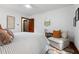 Spacious bedroom featuring a ceiling fan, wood floors and a cozy sitting area at 4703 Pleasant Green Rd, Durham, NC 27705