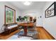 Bright dining room features hardwood floors, a modern rug, and views into a living room with a fireplace at 4703 Pleasant Green Rd, Durham, NC 27705