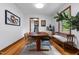 Bright dining room with wooden floors has a modern table with stylish chairs and a beautiful rug at 4703 Pleasant Green Rd, Durham, NC 27705
