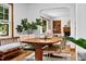 The dining room features a wooden table, bright windows, and a beautiful view of the fireplace in the living room at 4703 Pleasant Green Rd, Durham, NC 27705