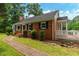 Charming brick home with manicured lawn and front porch at 4703 Pleasant Green Rd, Durham, NC 27705