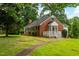 Charming brick home with well-maintained lawn and landscaping plus a screen porch at 4703 Pleasant Green Rd, Durham, NC 27705