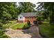 Exterior of brick house, featuring attached garage and manicured lawn at 4703 Pleasant Green Rd, Durham, NC 27705