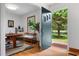 Bright foyer with hardwood floors, a view to the dining area, and an open front door at 4703 Pleasant Green Rd, Durham, NC 27705