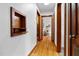 Inviting hallway with hardwood floors, wood trim and access to other rooms at 4703 Pleasant Green Rd, Durham, NC 27705