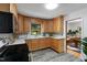 Updated kitchen features stainless steel appliances, blue backsplash, and a view into the adjacent dining room at 4703 Pleasant Green Rd, Durham, NC 27705