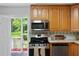 Updated kitchen features stainless steel appliances, a black range and backsplash access to deck and backyard at 4703 Pleasant Green Rd, Durham, NC 27705