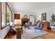 Cozy living room with hardwood floors, a fireplace, natural light, and stylish furnishings at 4703 Pleasant Green Rd, Durham, NC 27705