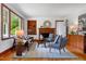 Inviting living room featuring fireplace, stylish seating, hardwood floors, and natural light at 4703 Pleasant Green Rd, Durham, NC 27705