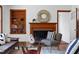 Bright living room featuring fireplace, stylish seating, and built in shelving for display at 4703 Pleasant Green Rd, Durham, NC 27705